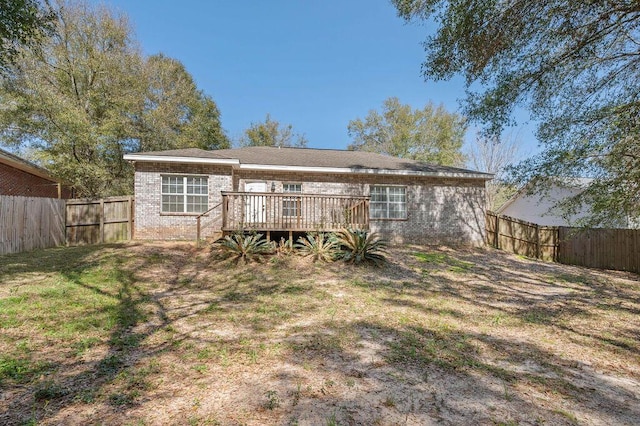 132 Lonnie Jack Dr, Crestview, FL 32536 - back of property featuring a deck, a yard, a fenced backyard, and brick siding