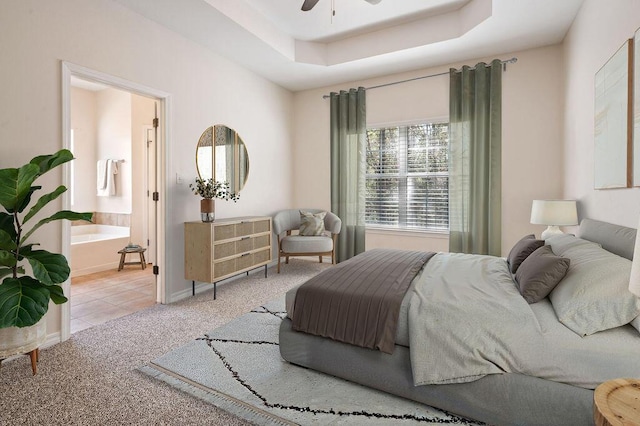 132 Lonnie Jack Dr, Crestview, FL 32536 - carpeted bedroom featuring tile patterned floors, a tray ceiling, baseboards, and ensuite bathroom