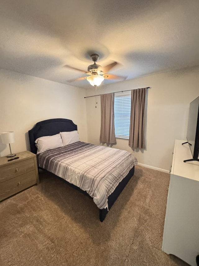 bedroom featuring baseboards, ceiling fan, and dark colored carpet