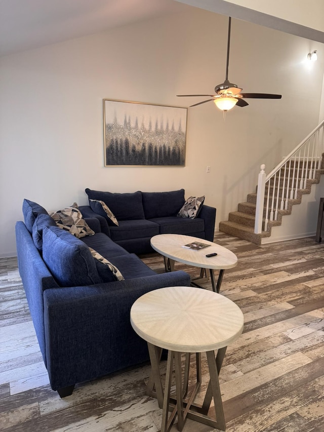 living room featuring ceiling fan, stairway, lofted ceiling, and wood finished floors