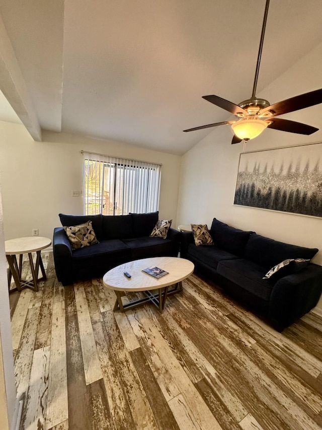 living area with vaulted ceiling, a ceiling fan, and wood-type flooring