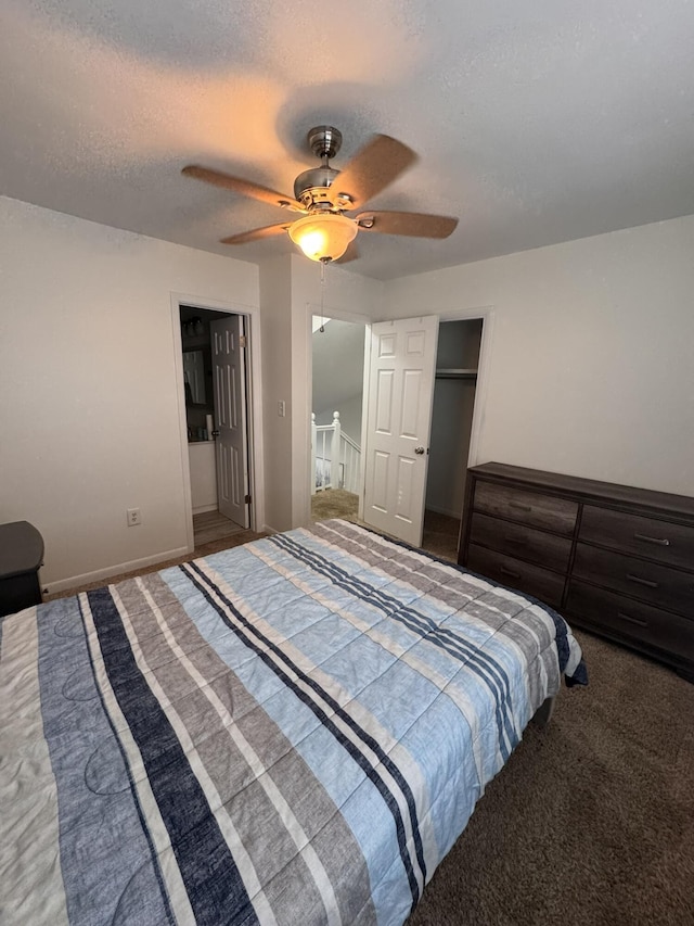 bedroom featuring baseboards, ceiling fan, a closet, a textured ceiling, and carpet flooring