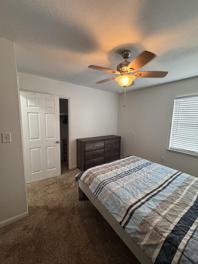 bedroom featuring carpet flooring, ceiling fan, a textured ceiling, and baseboards