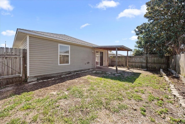 back of house featuring a patio area, a lawn, and a fenced backyard