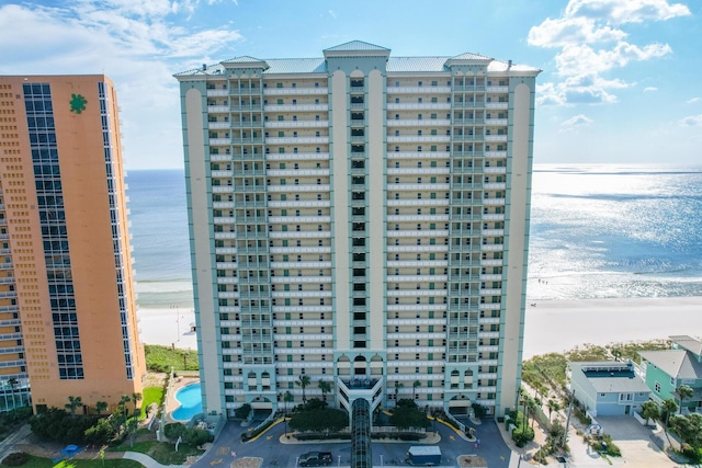 view of property featuring a water view and a beach view