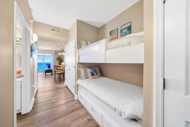 bedroom with baseboards, visible vents, and light wood-style floors