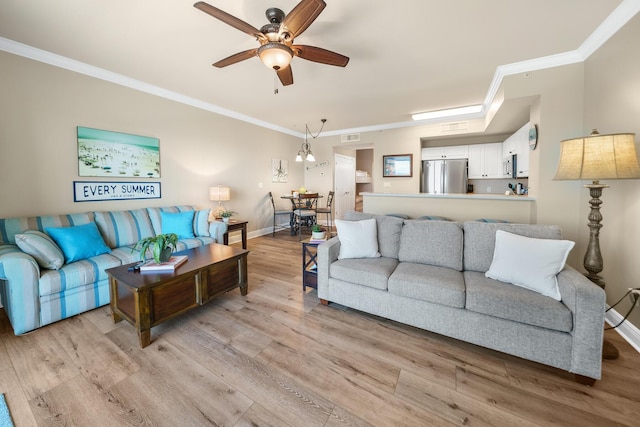 living room featuring baseboards, crown molding, visible vents, and light wood finished floors