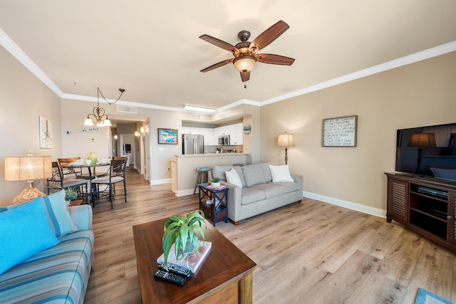 living area with baseboards, light wood-style floors, visible vents, and crown molding