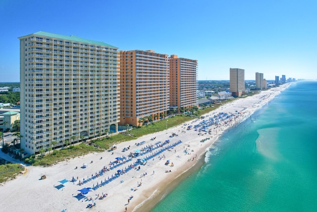 aerial view featuring a water view, a view of city, and a view of the beach