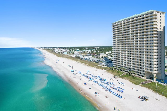 bird's eye view featuring a water view and a beach view