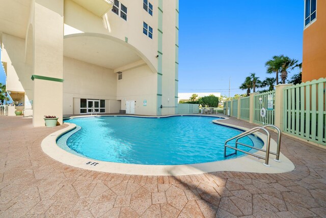 pool featuring a patio area and fence