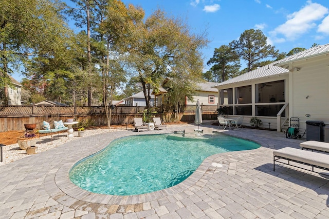 view of pool with a fenced in pool, ceiling fan, a fenced backyard, a sunroom, and a patio