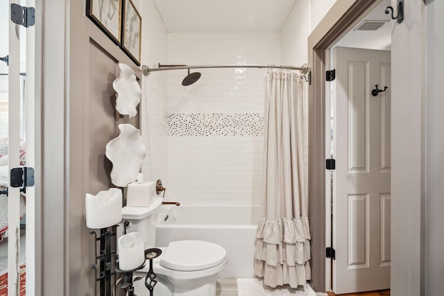 bathroom with visible vents, shower / tub combo with curtain, and toilet