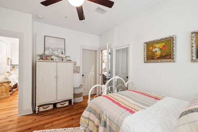 bedroom featuring visible vents, ceiling fan, and wood finished floors