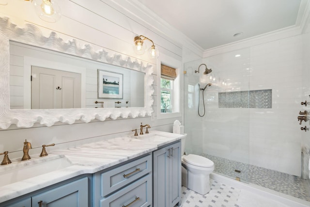 full bath featuring crown molding, toilet, double vanity, tiled shower, and a sink