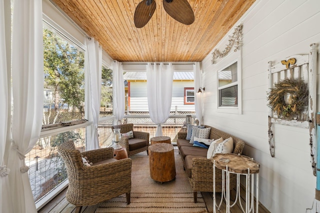 sunroom / solarium featuring wooden ceiling and a ceiling fan