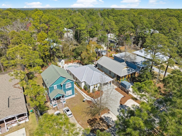 birds eye view of property featuring a view of trees