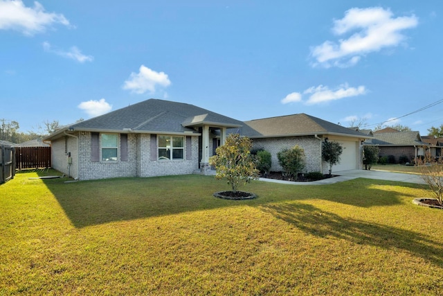 view of front facade with brick siding, concrete driveway, a front yard, fence, and a garage