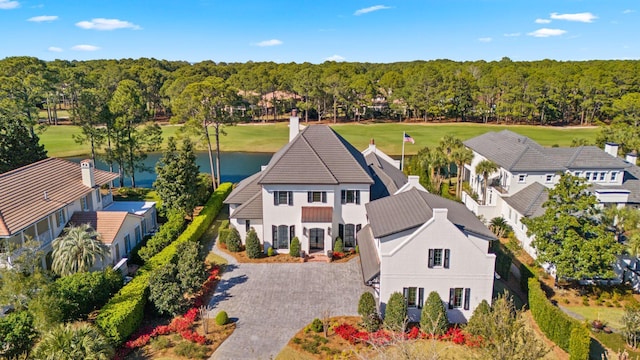 birds eye view of property with a water view and a forest view