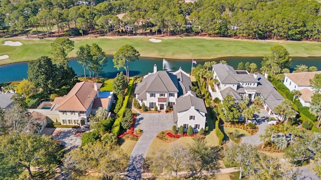 birds eye view of property featuring golf course view, a water view, and a residential view