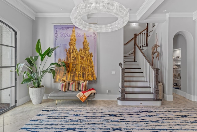 tiled foyer entrance with stairway, baseboards, and ornamental molding