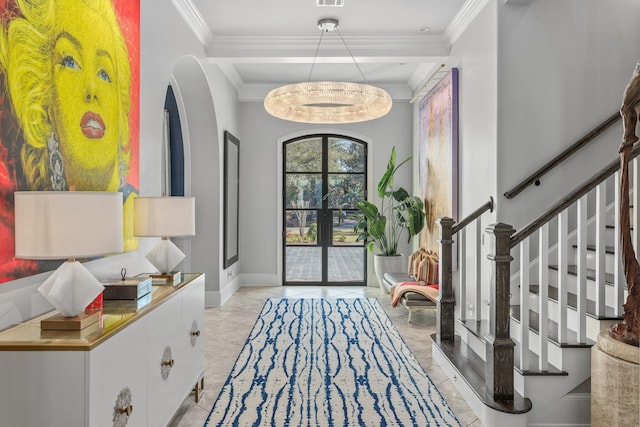 entryway featuring arched walkways, crown molding, visible vents, baseboards, and stairs