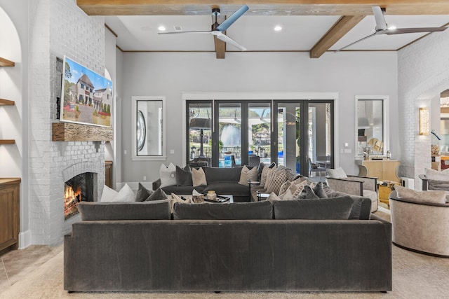 living area with a ceiling fan, a towering ceiling, beamed ceiling, a fireplace, and recessed lighting