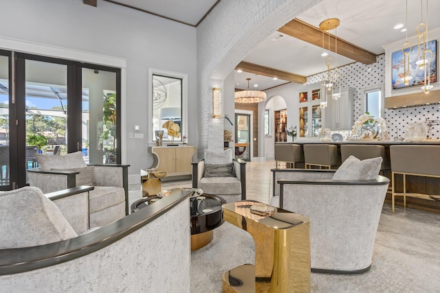 living area with arched walkways, beamed ceiling, and recessed lighting