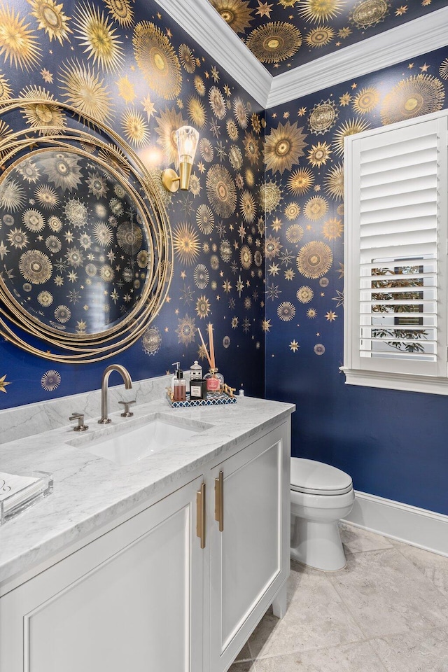 half bath with toilet, tile patterned flooring, vanity, and baseboards