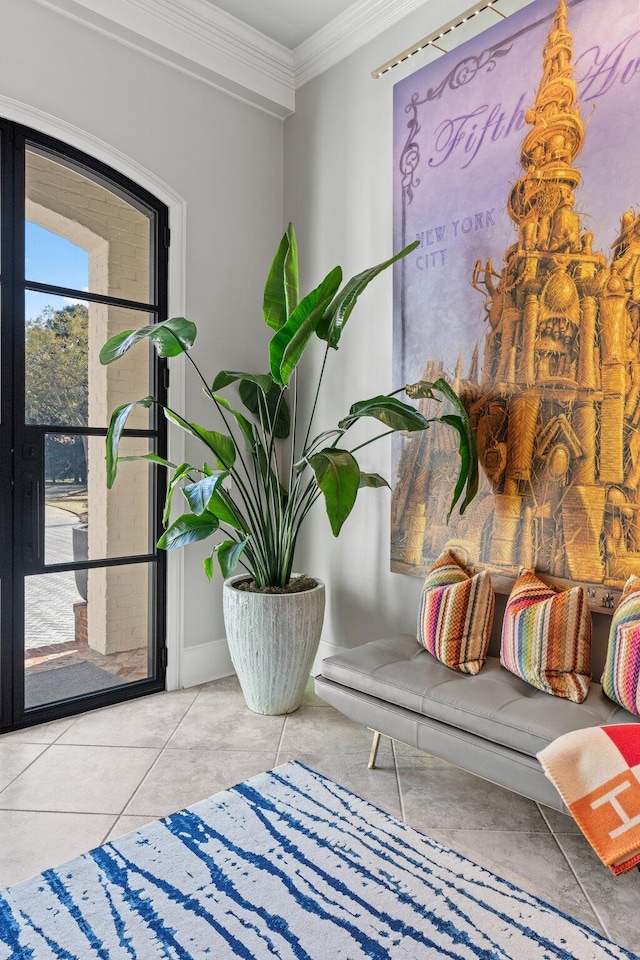 living area with crown molding, baseboards, and tile patterned floors