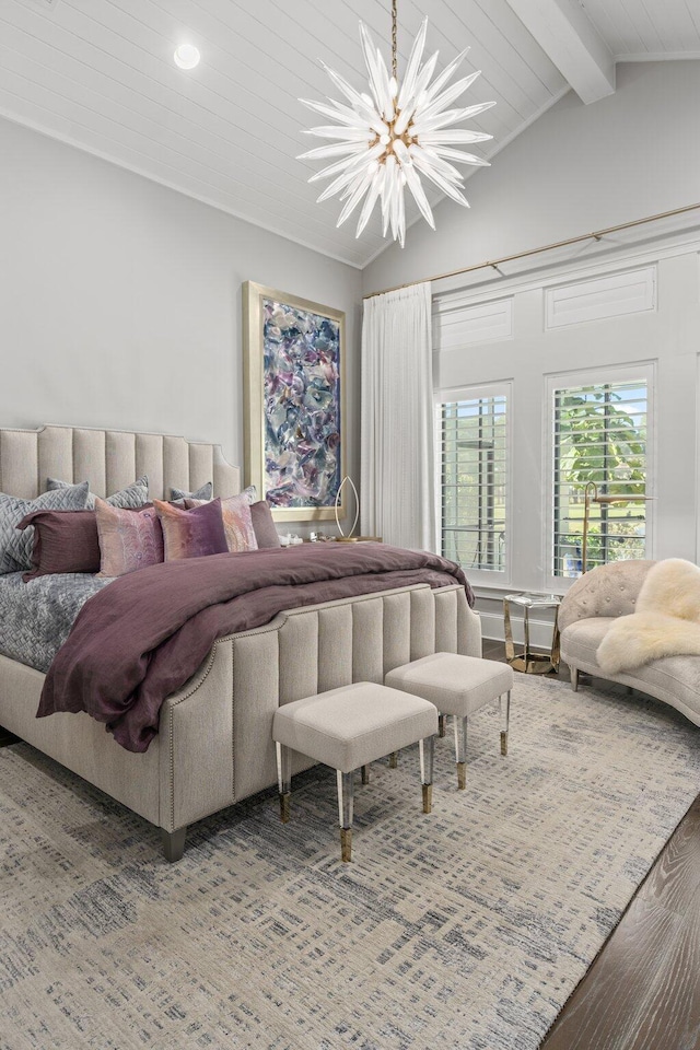 bedroom featuring lofted ceiling with beams, wood finished floors, and a chandelier