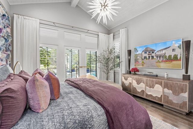 bedroom featuring a notable chandelier, beam ceiling, high vaulted ceiling, and wood finished floors