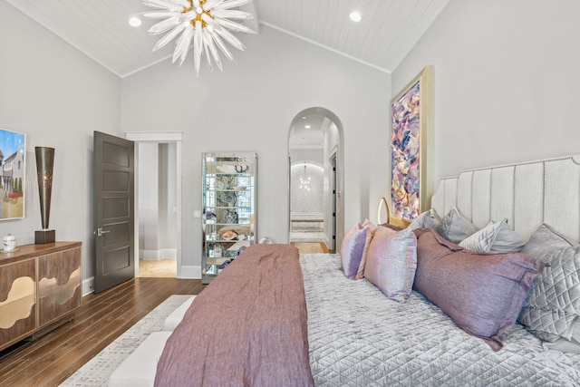 bedroom with arched walkways, crown molding, wood finished floors, high vaulted ceiling, and baseboards