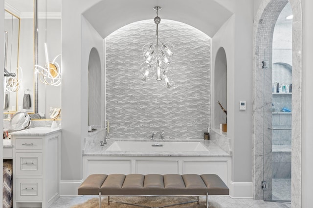 bathroom featuring a stall shower, vanity, baseboards, and an inviting chandelier