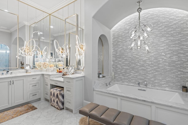 full bath with a chandelier, a garden tub, vanity, marble finish floor, and crown molding