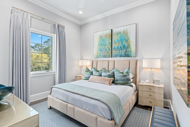 bedroom with baseboards, ornamental molding, and wood finished floors