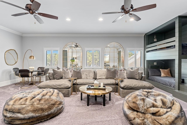 living area featuring crown molding, carpet, plenty of natural light, and baseboards