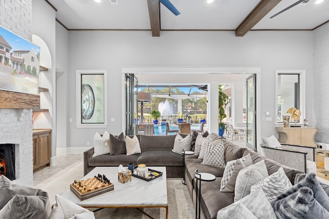 living area with recessed lighting, beamed ceiling, a brick fireplace, and baseboards