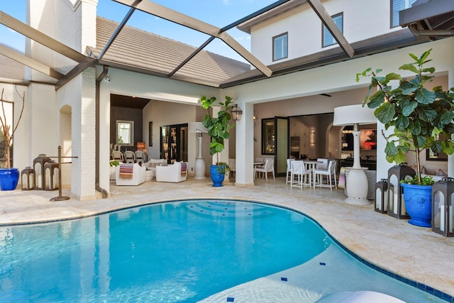 back of house featuring a patio, a lanai, an outdoor living space, and an outdoor pool