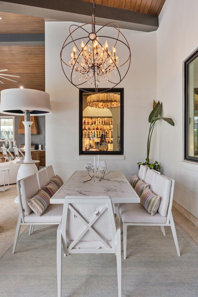 dining space with wooden ceiling, breakfast area, beamed ceiling, and carpet flooring