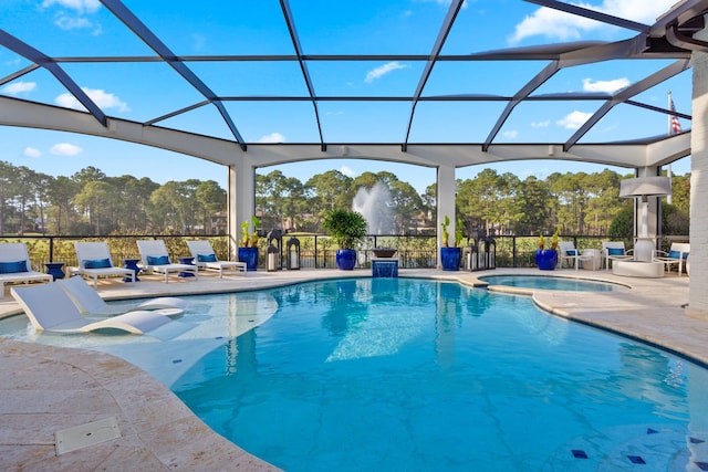 view of swimming pool with glass enclosure, a patio area, and a pool with connected hot tub