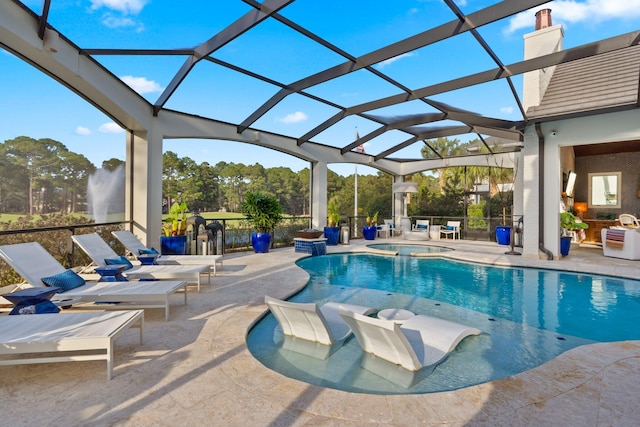 outdoor pool featuring an in ground hot tub, a patio area, and glass enclosure