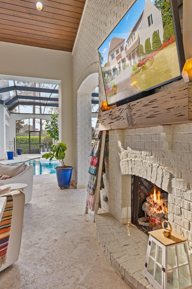 view of patio / terrace with glass enclosure, an outdoor brick fireplace, and an outdoor pool