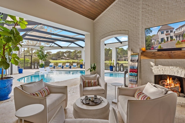 view of patio / terrace featuring glass enclosure, an outdoor living space with a fireplace, and an outdoor pool