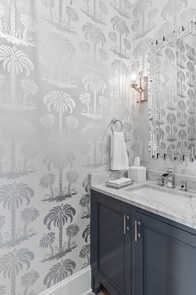 bathroom featuring vanity and wallpapered walls