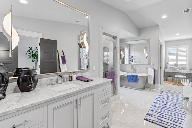 bathroom featuring marble finish floor, visible vents, a stall shower, vanity, and a freestanding tub