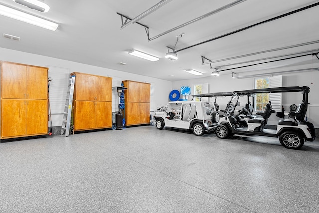 garage featuring visible vents and a garage door opener