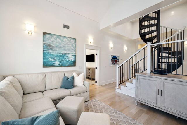 254 E Yacht Pond Ln, Watersound, FL 32461 - living room featuring high vaulted ceiling, visible vents, light wood finished floors, baseboards, and stairs