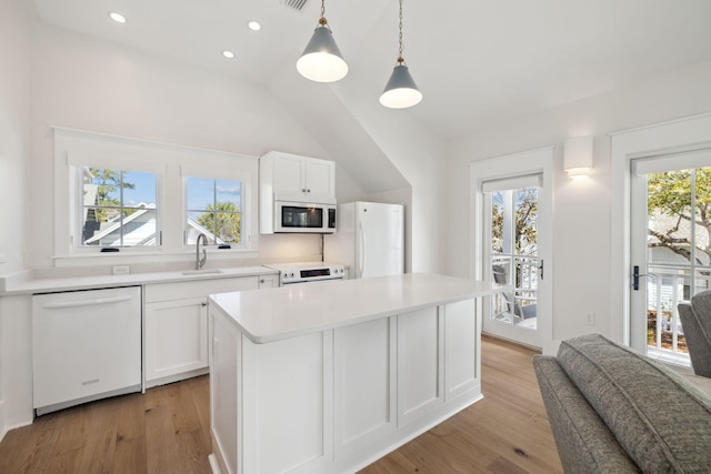 254 E Yacht Pond Ln, Watersound, FL 32461 - kitchen with white cabinetry, a sink, light wood finished floors, and white appliances