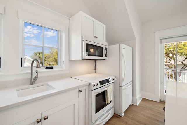 254 E Yacht Pond Ln, Watersound, FL 32461 - kitchen with white cabinetry, light countertops, white appliances, a sink, and light wood-style floors